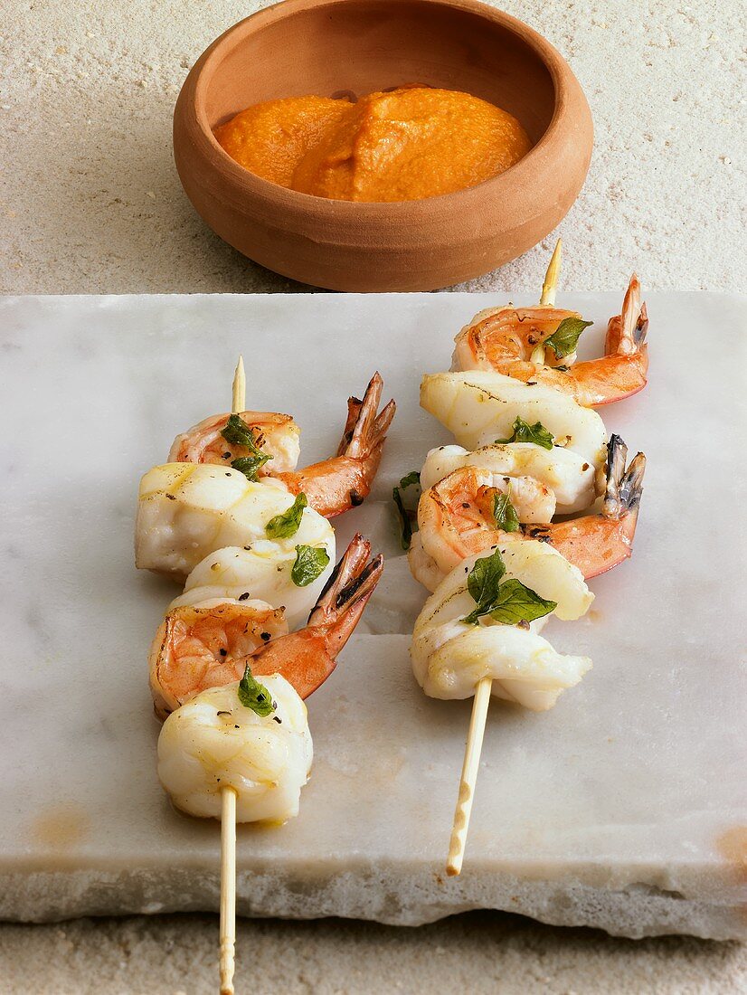 Skewered shrimps with romesco sauce