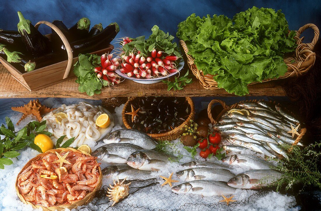 Still life with fish, seafood, herbs and vegetables