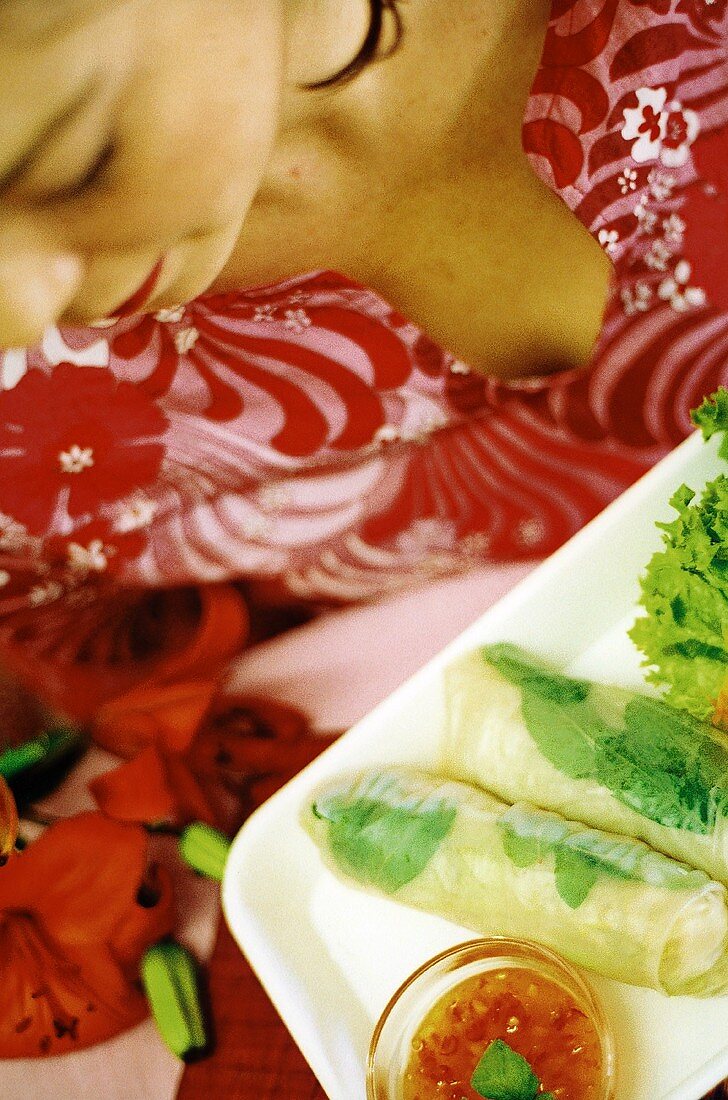 European woman eating Vietnamese spring rolls (surreal)
