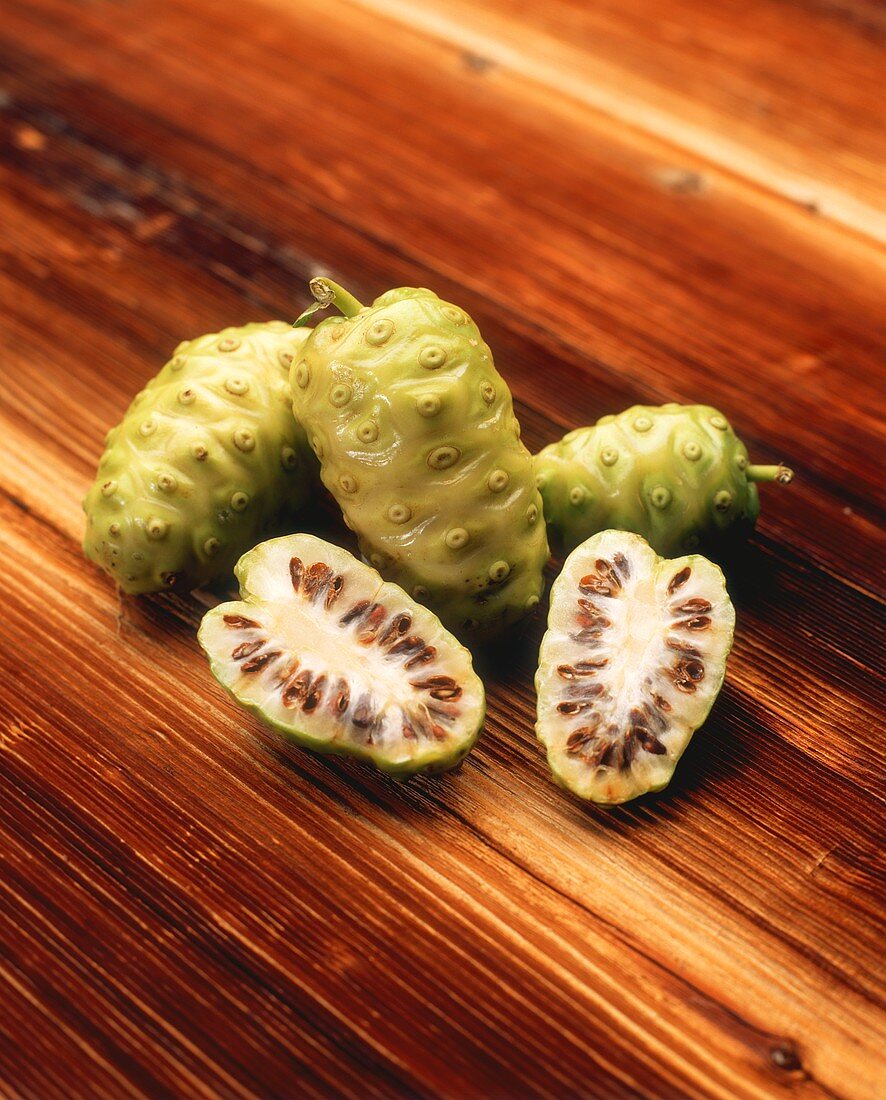 Noni on wooden background