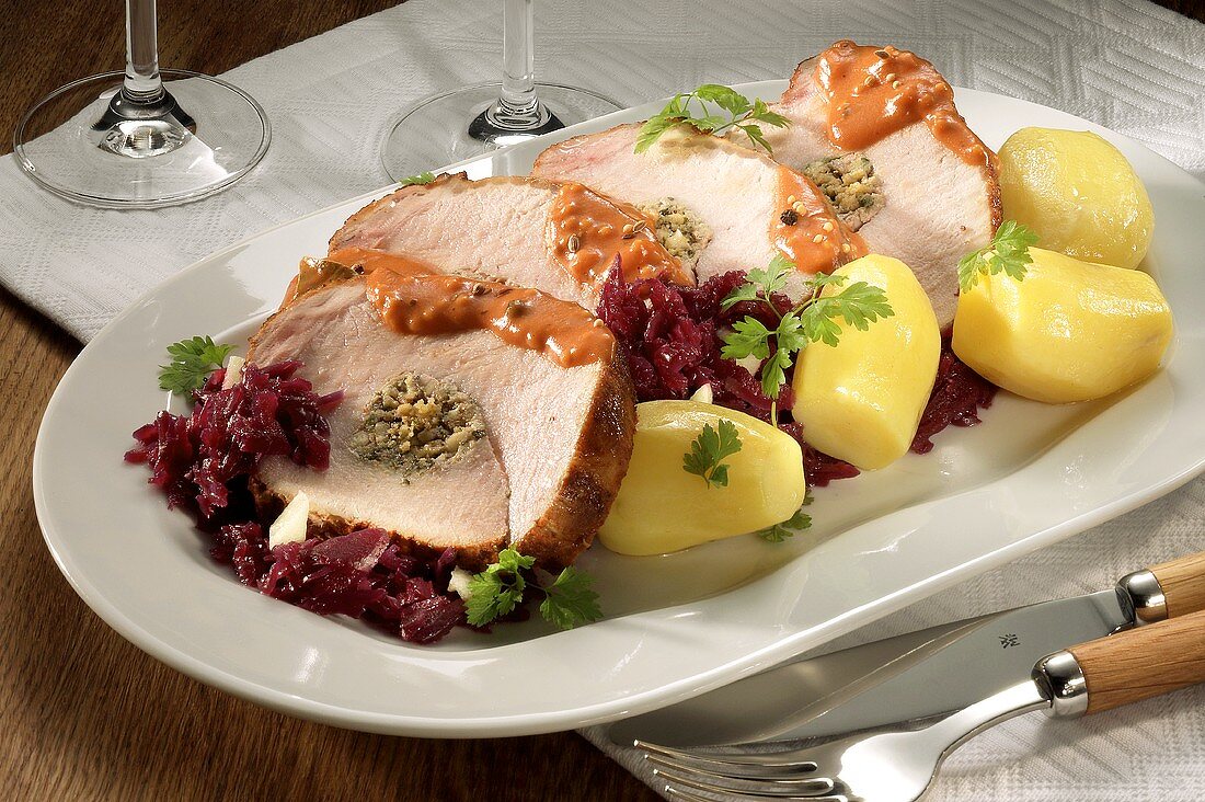 Stuffed rolled pork joint with red cabbage and boiled potatoes