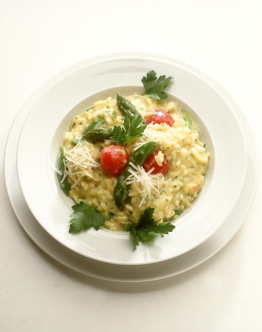 Asparagus risotto with green asparagus and cherry tomatoes