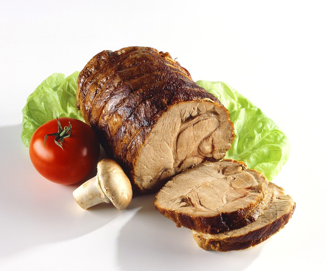 Rolled roast, slices carved, with salad decoration