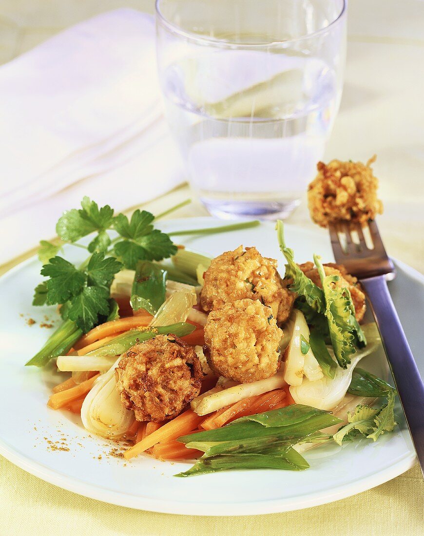 Deep-fried dumplings on vegetables