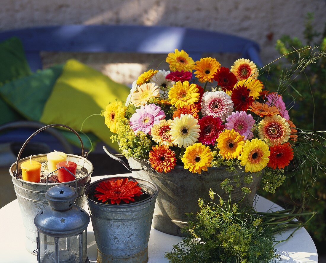 Table decoration with zinc pails, candles and gerberas 