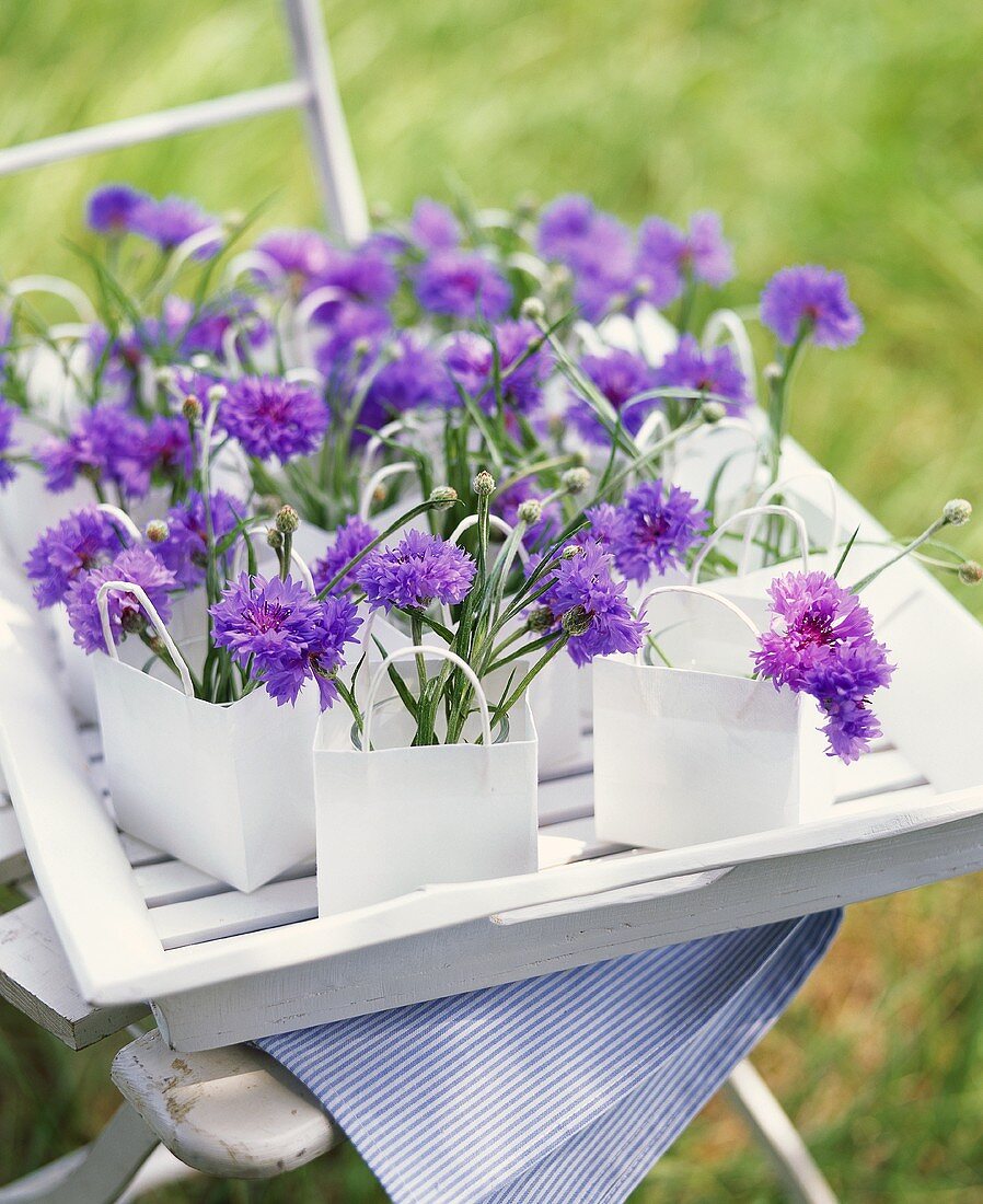 Original table decoration with cornflowers in paper bags