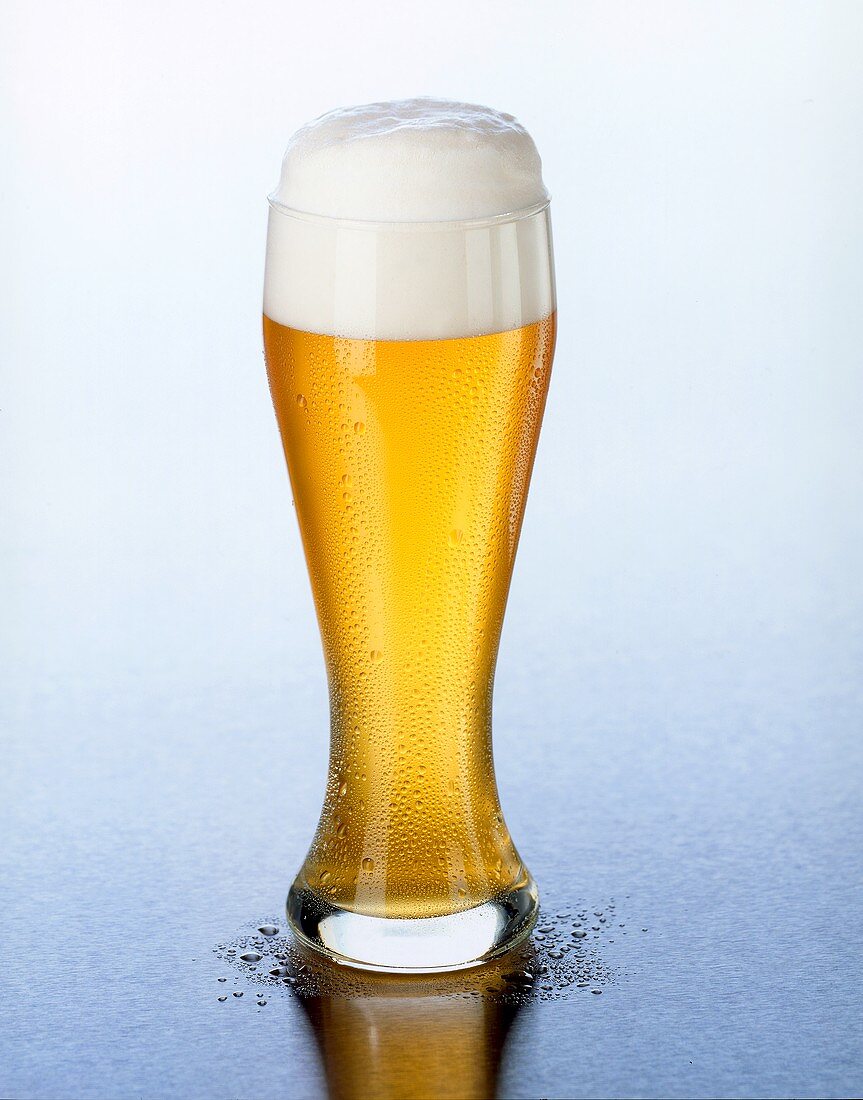Weissbier (wheat beer) with head of foam in Weissbier glass