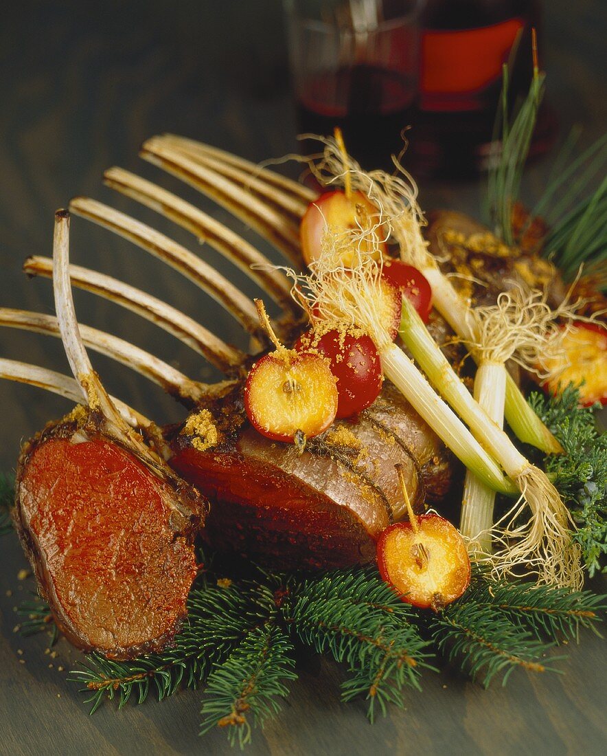 Rack of lamb with apples and leeks on fir branches