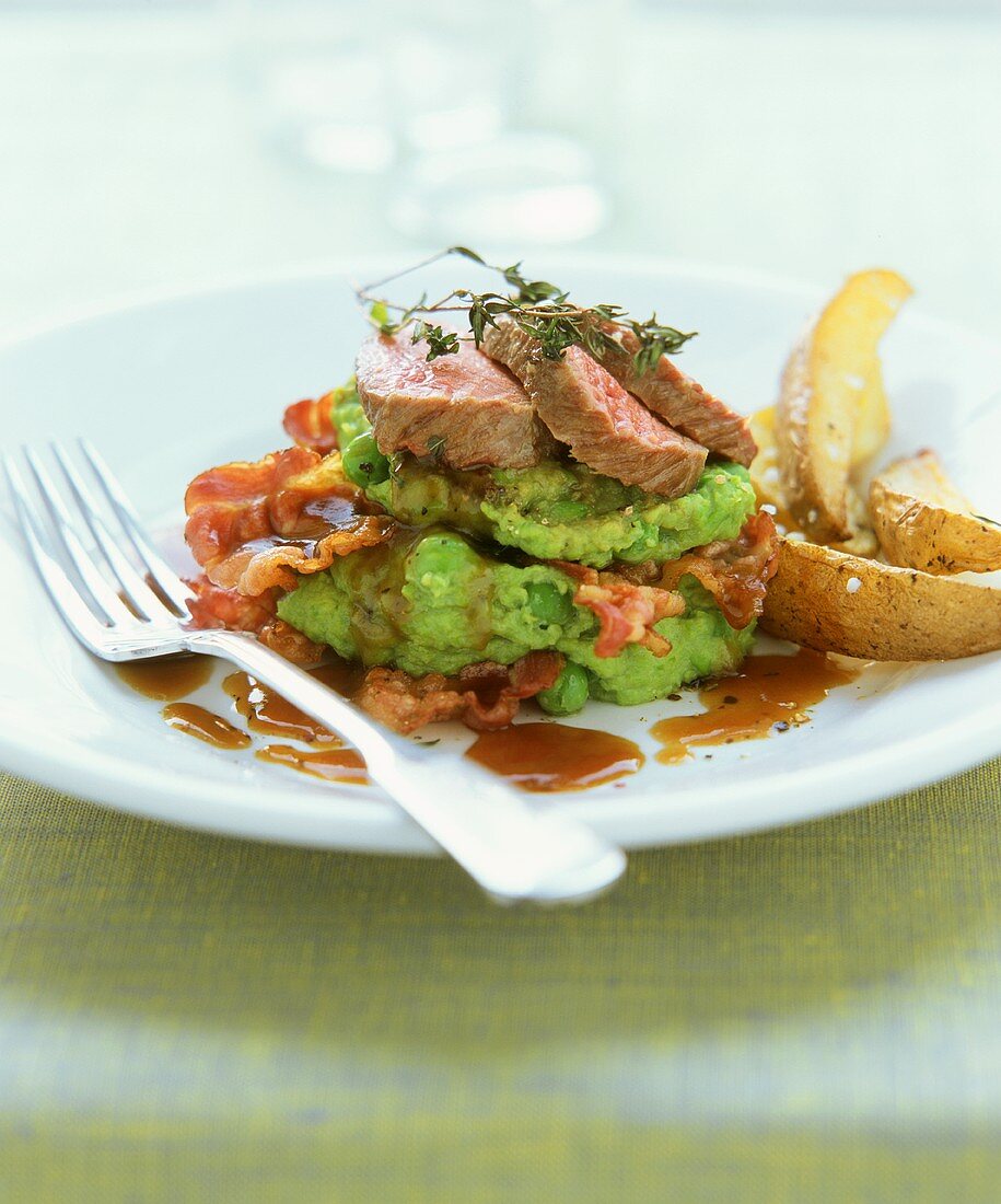 Lamb fillet on pea puree with bacon and balsamic sauce