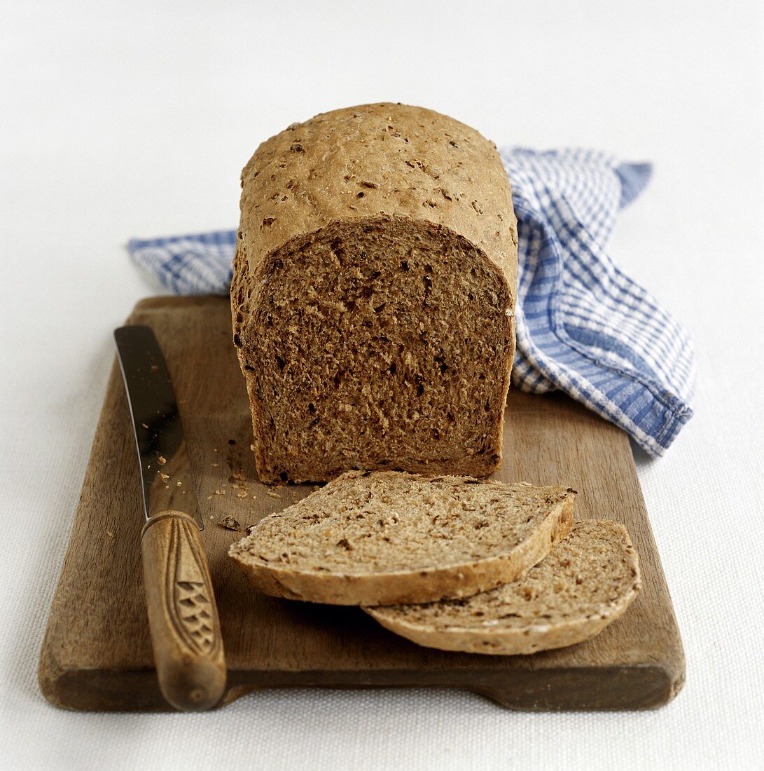 Wholemeal bread, slices cut on a wooden board