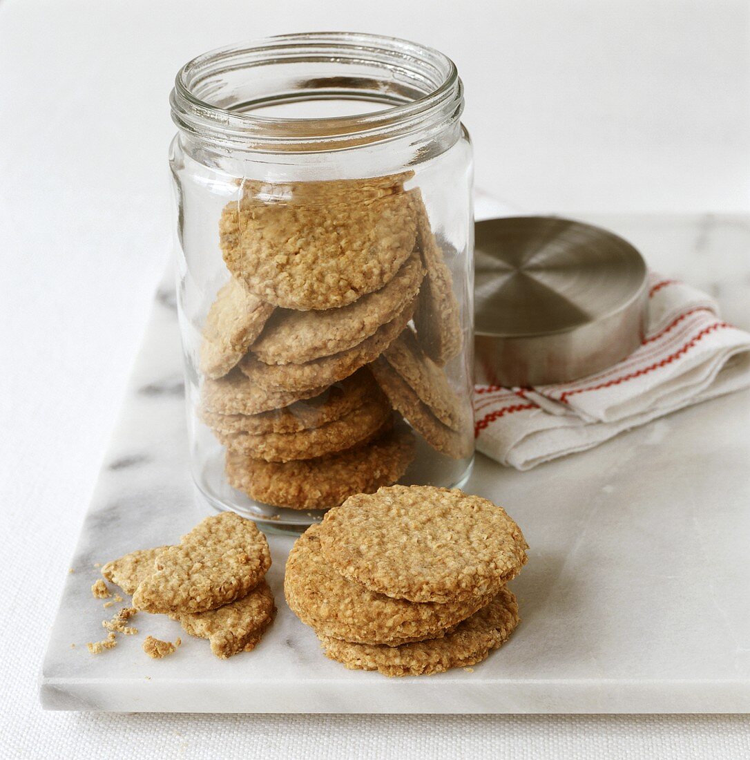 Ginger oat biscuits in and beside jar