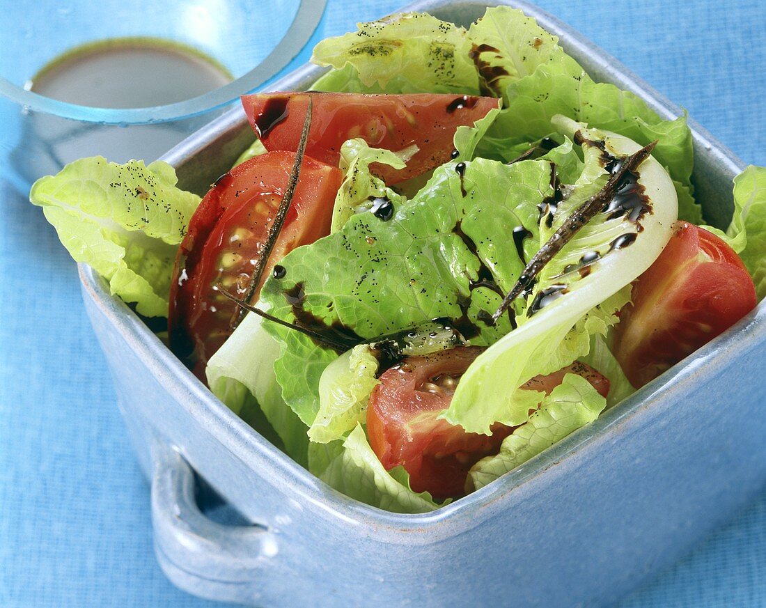 Romaine lettuce with tomatoes and oil and vinegar dressing