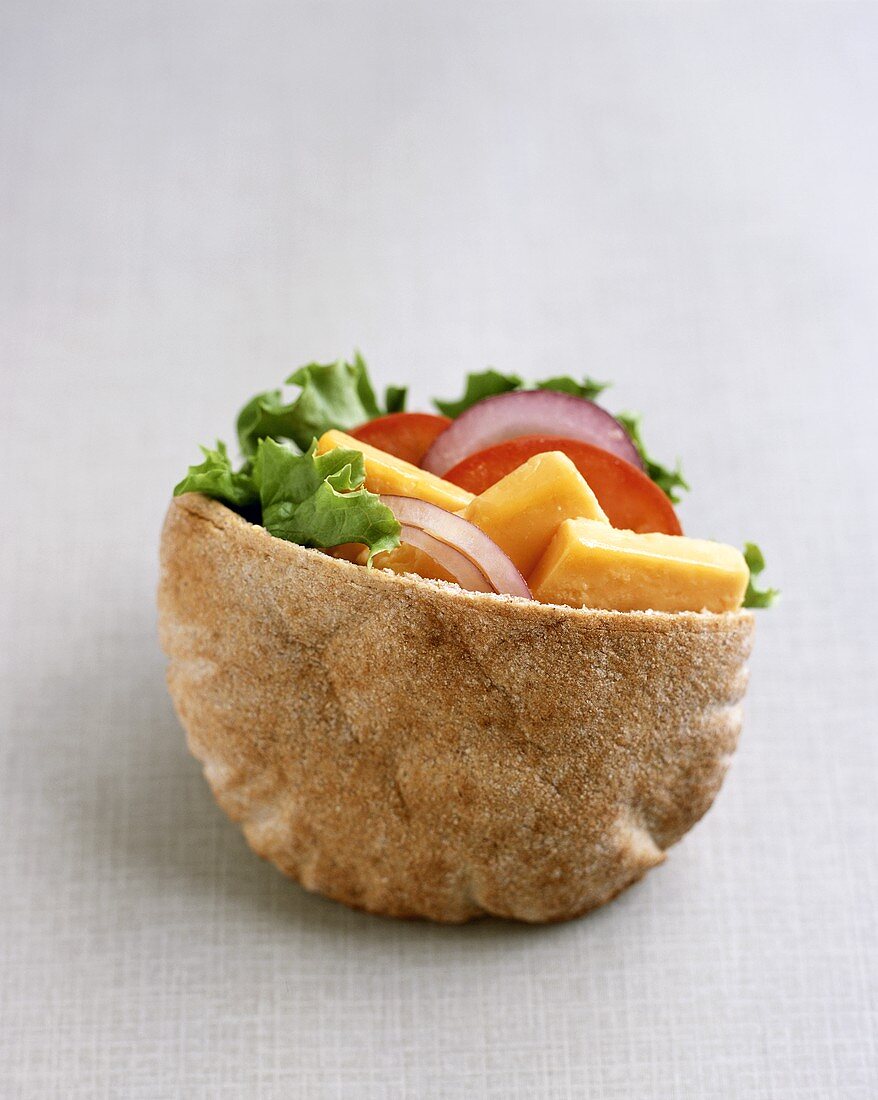 Pita bread filled with Cheddar cheese and salad