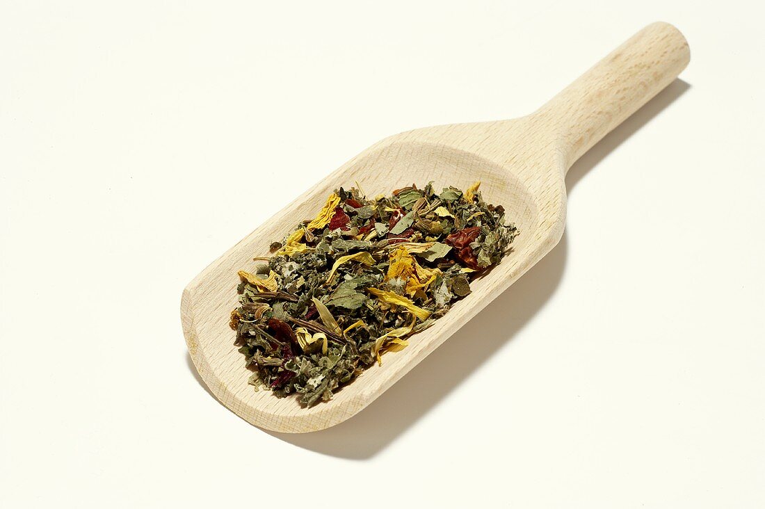 Wellness tea mixture in a wooden scoop