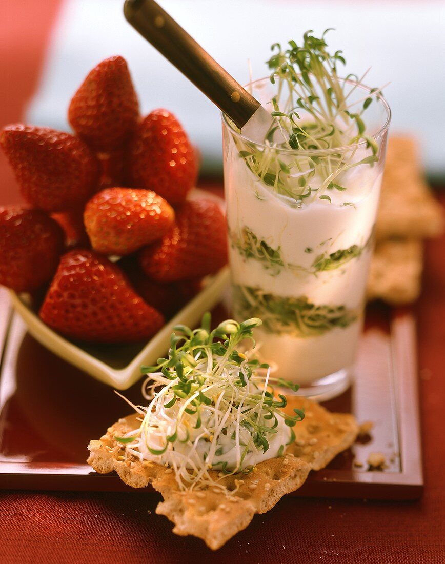 Sprout salad, crispbread with topping and strawberries