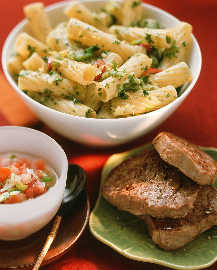 Beef fillets with tomato sauce and penne with herbs