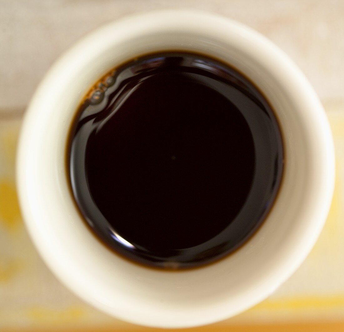 Soy sauce in a small white bowl
