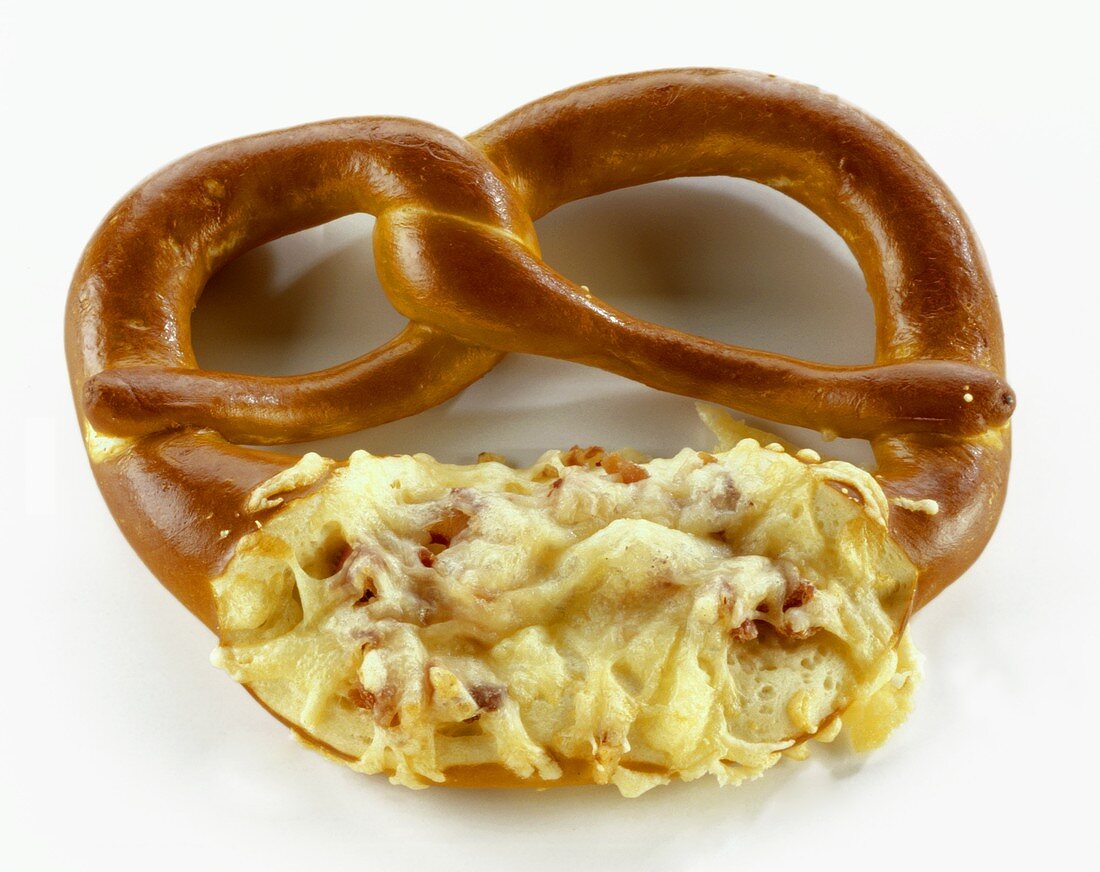 A pretzel with toasted cheese and ham
