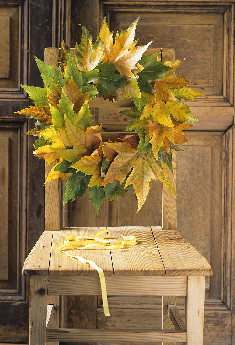 A chair with a wreath of leaves