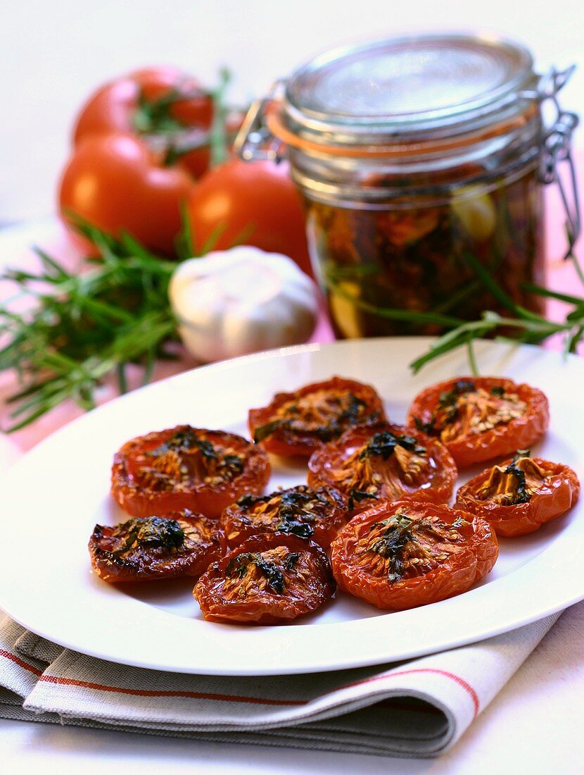 Dried tomatoes on a plate and in a jar