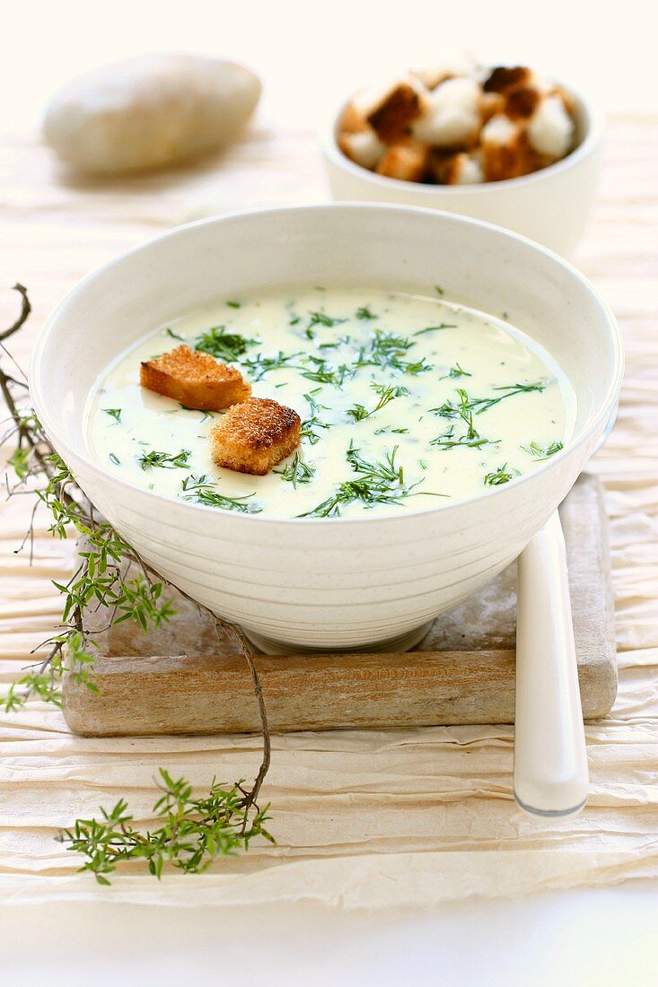 A bowl of cheese soup with croutons