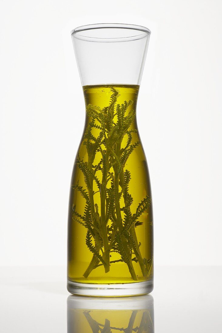 Oil with herbs in a carafe