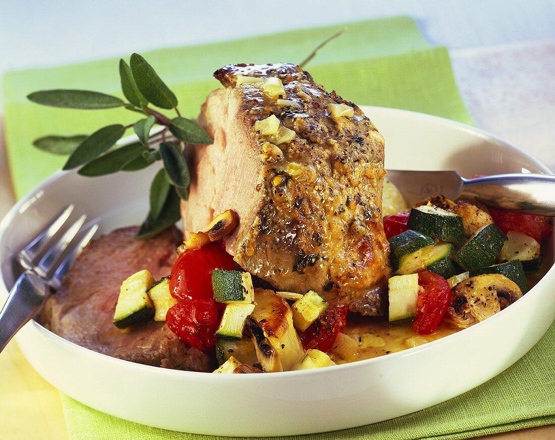 Roast pork with tomatoes, courgettes and mushrooms