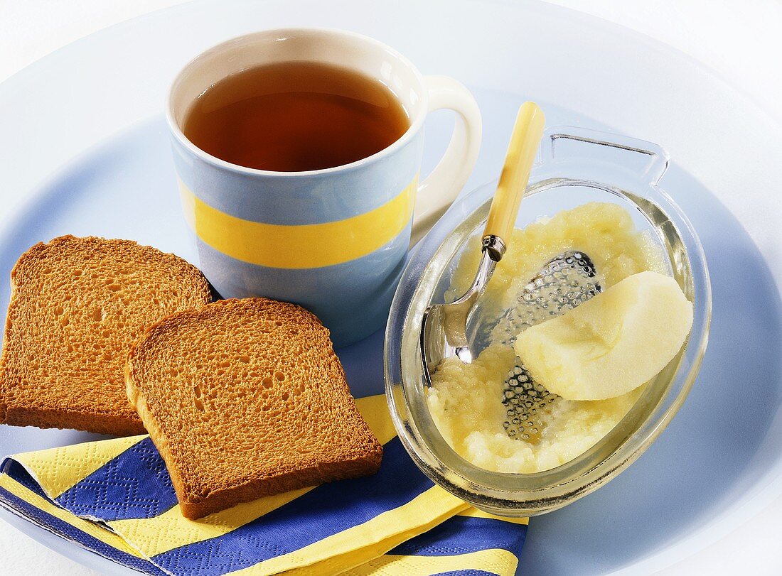 Tea, zwieback (rusk) and grated apple (light diet for children)