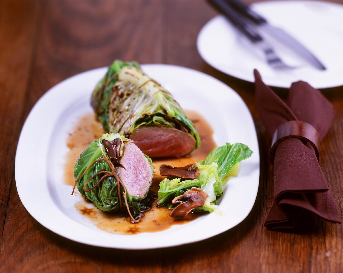 Pork fillet wrapped in savoy cabbage with mushroom sauce