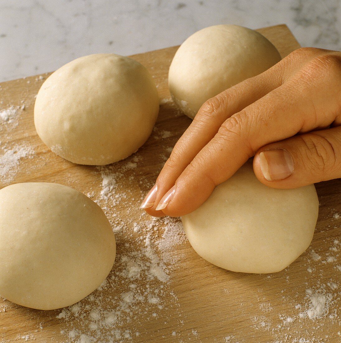 Making bagels: shaping balls of dough