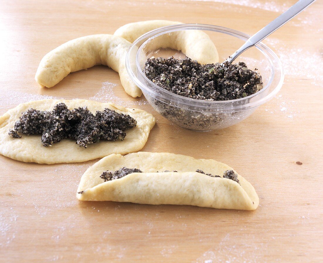 Filling croissant with poppy seeds