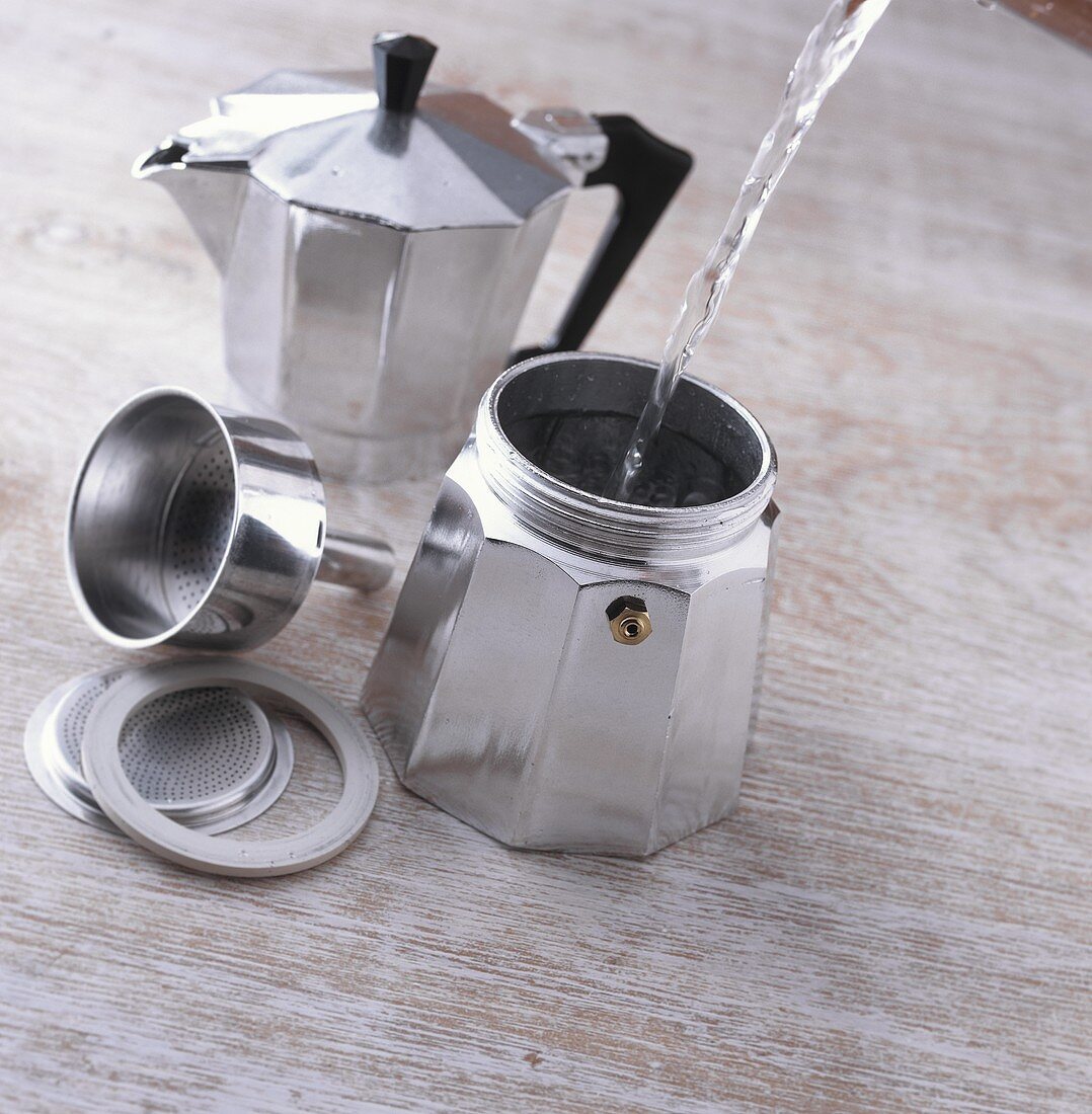 Making espresso: filling espresso pot with water