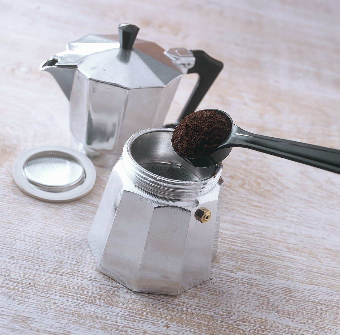 Making espresso: filling strainer with coffee powder