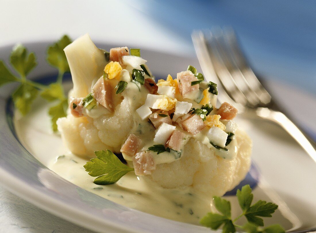 Cauliflower with herb sauce, diced ham, and egg