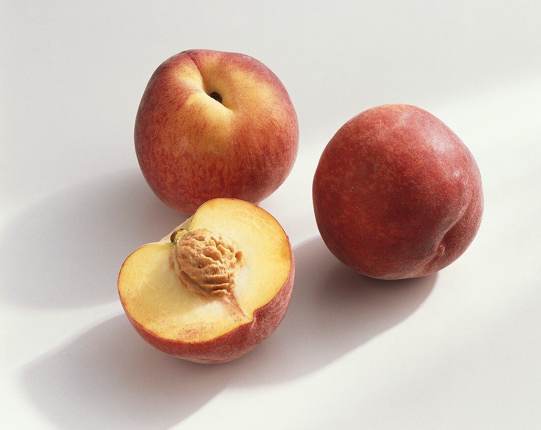 Peach, variety ‘Flavor Crest’, whole and halved