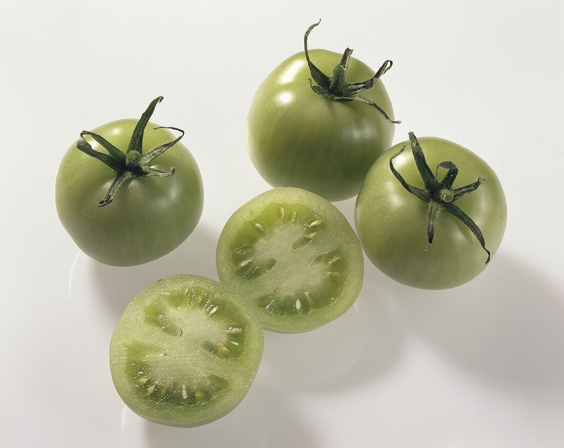 Green tomatoes (Lycopersicon esculentum), one halved