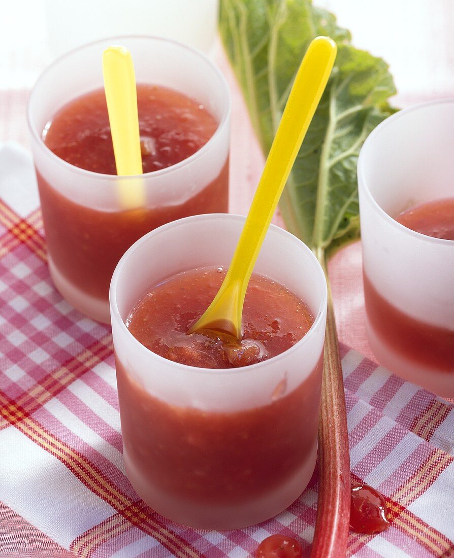 Rhubarb, strawberry and orange jam in glasses with spoons