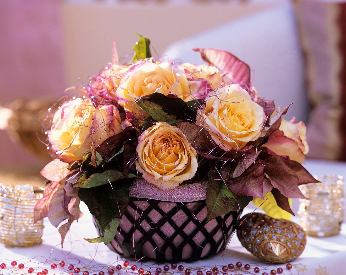 'Geisha' rose and poinsettia in metal basket