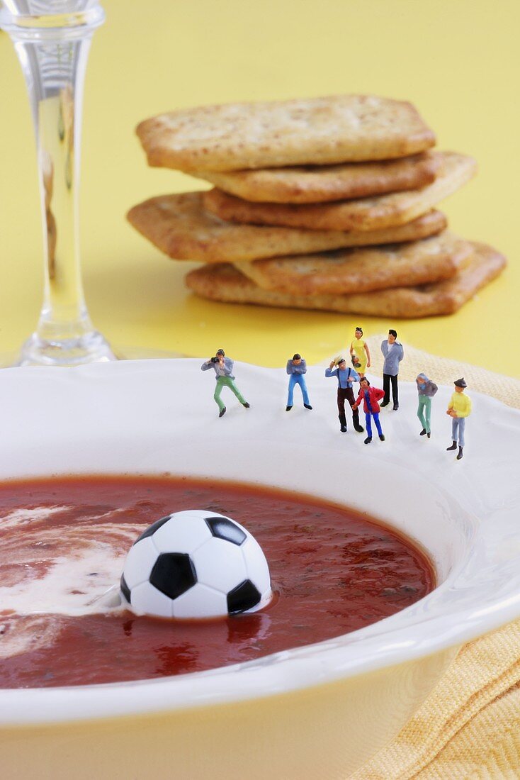 Sightseers looking at ball floating in tomato soup