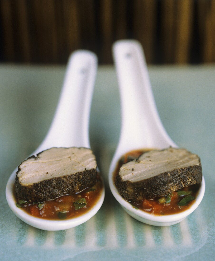 Pork fillet in pepper sauce on two spoons (Vietnam)