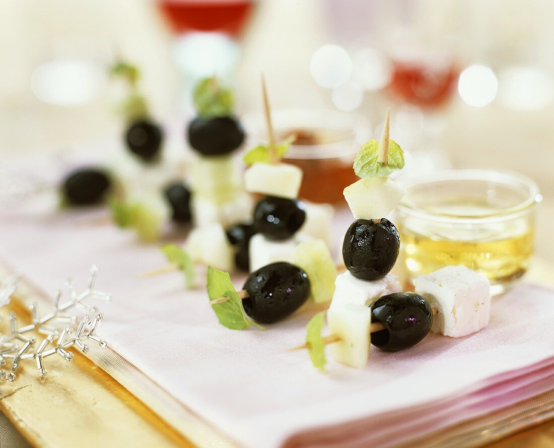 Olives, feta and melon on cocktail sticks