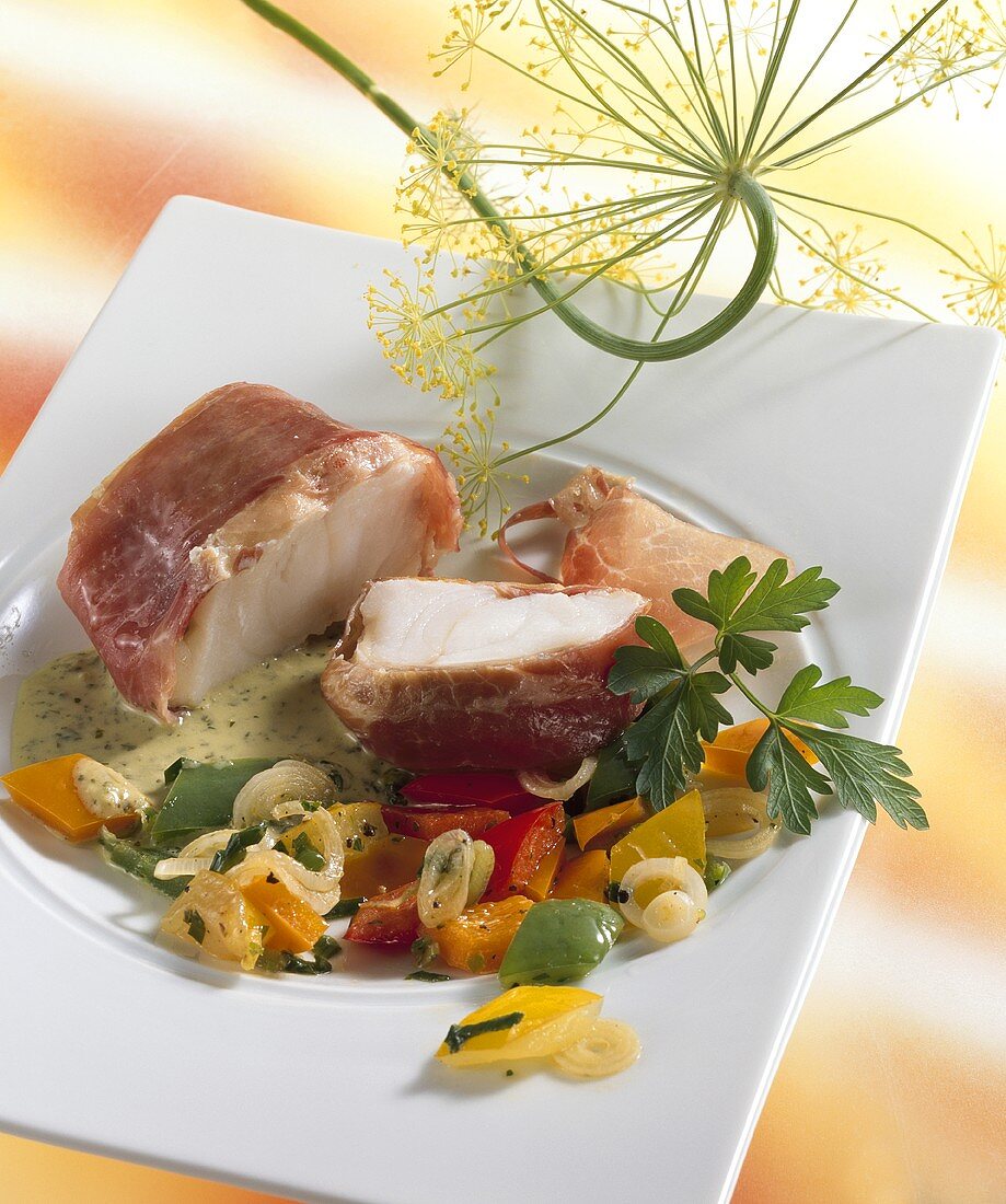 Monkfish medallions wrapped in ham with peppers