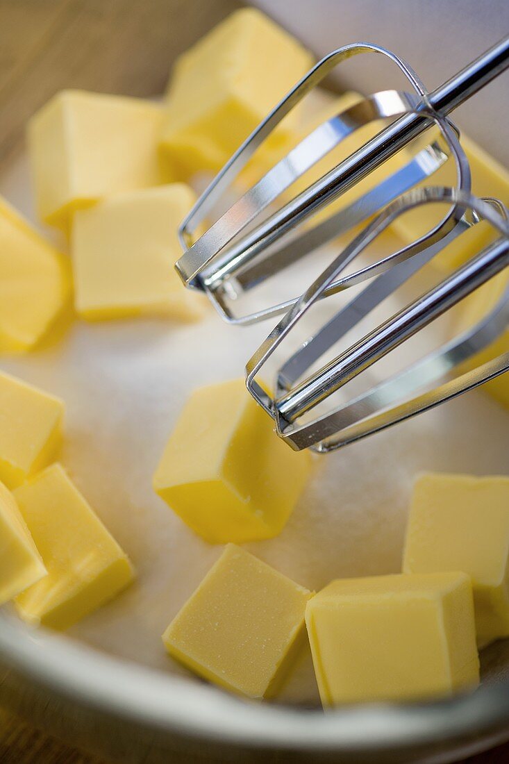 Baking ingredients: sugar and butter with two beaters