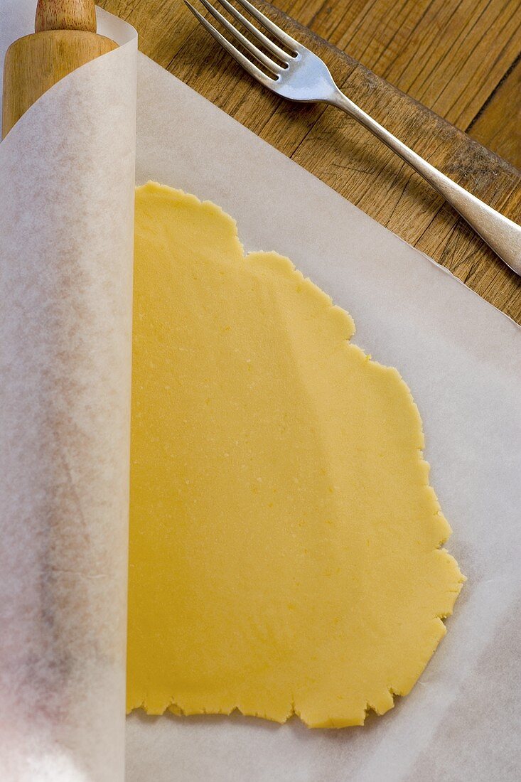 Rolled out pastry on baking parchment