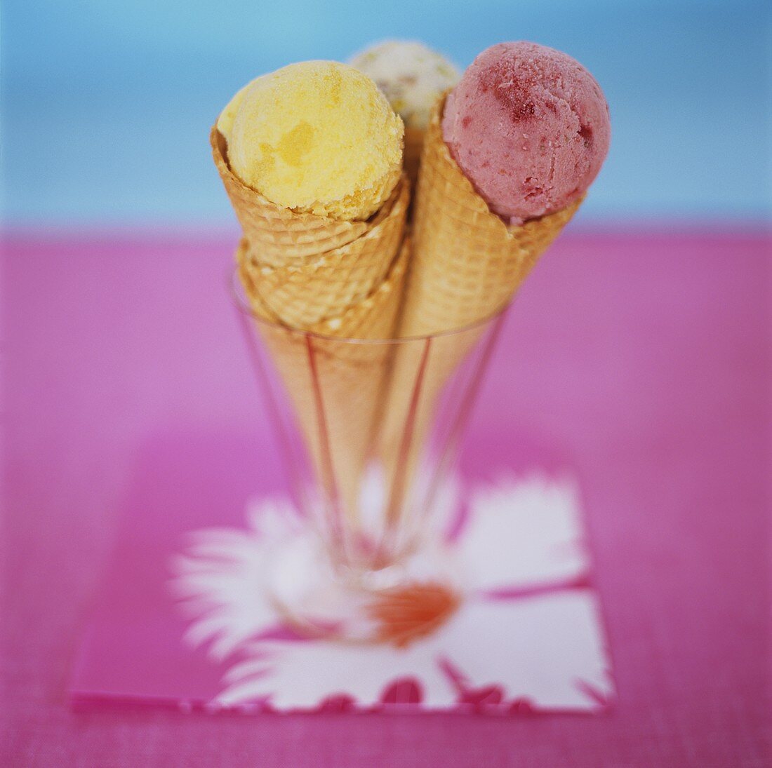 Three scoops of ice cream in three ice cream cones