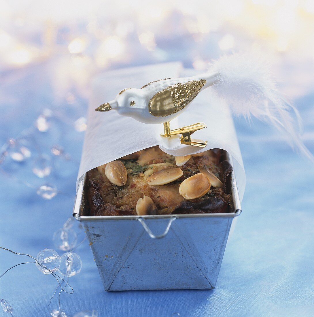 Meat pâté with almonds in a dish with Christmas decoration