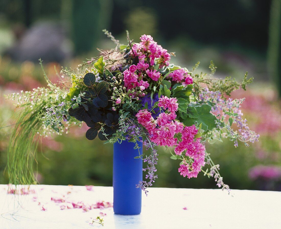 Cascading arrangement of roses and grasses