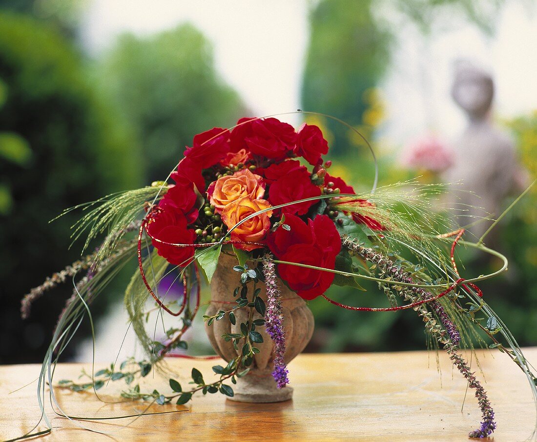 Small bouquet of begonias with roses and grasses