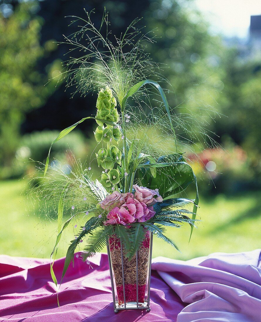 Delicate grasses with hydrangea, coral fern & bells of Ireland