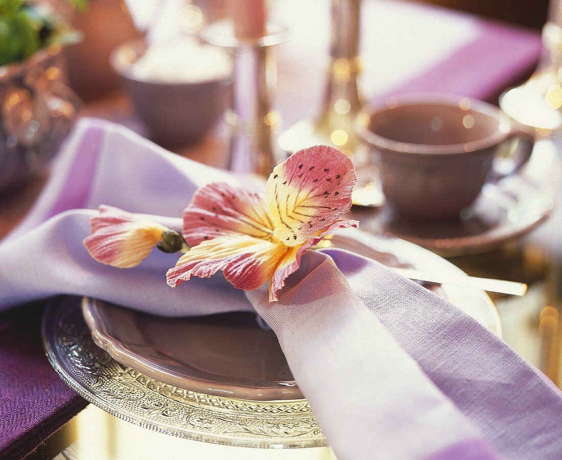 Fabric flower with napkin on a plate